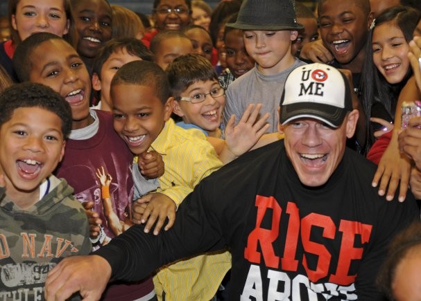 ​John Cena poses for a picture with a group of children