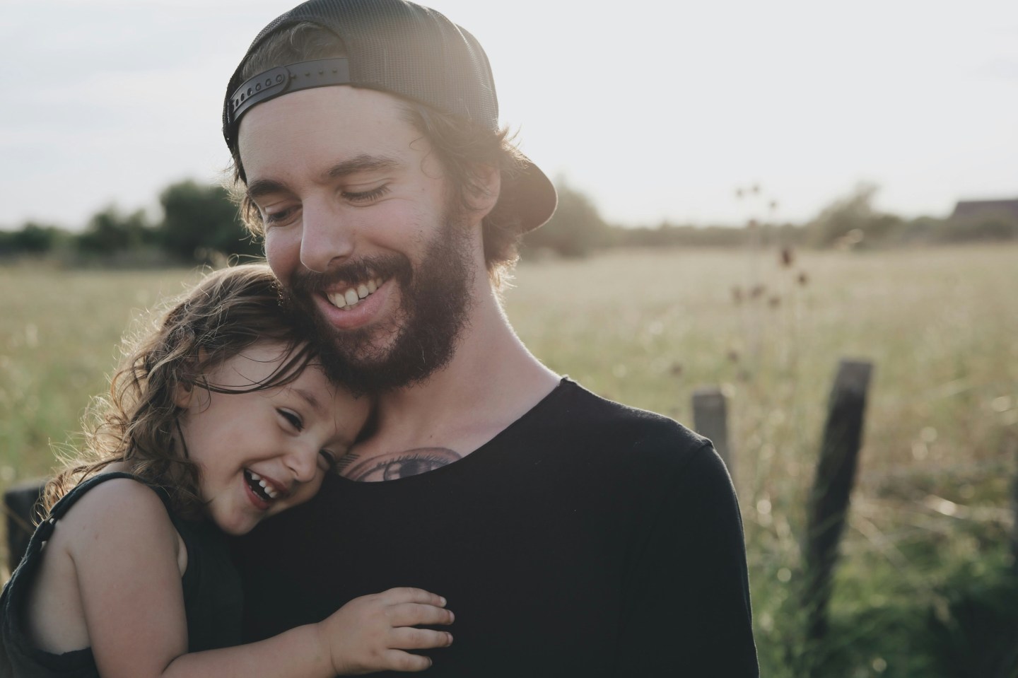 A dad holds his young daughter