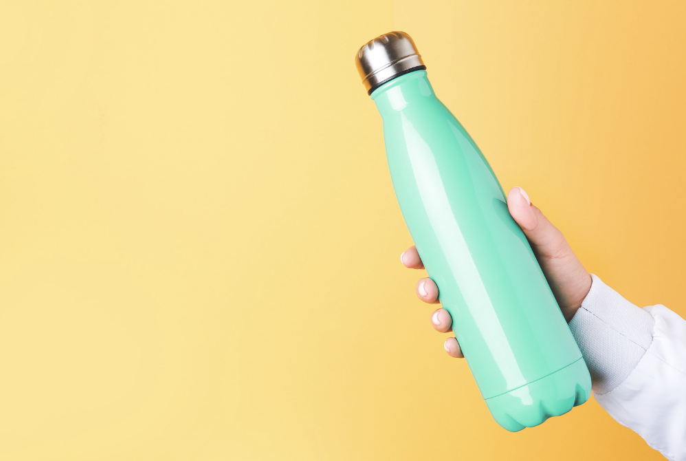 Hand holding metal water bottle