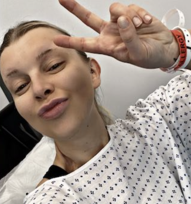 Katherine Murrell taking a selfie in a hospital gown