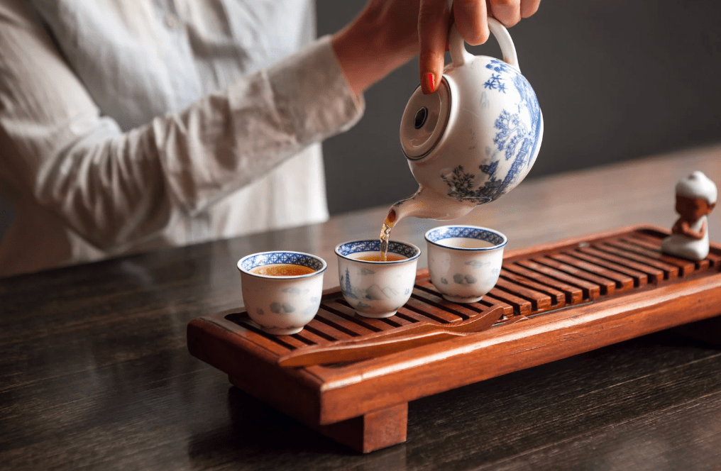 Woman pouring tea.