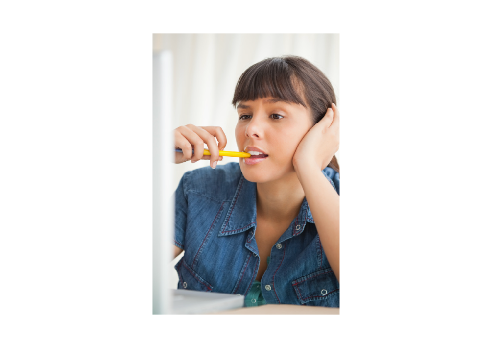 Woman chewing on pencil