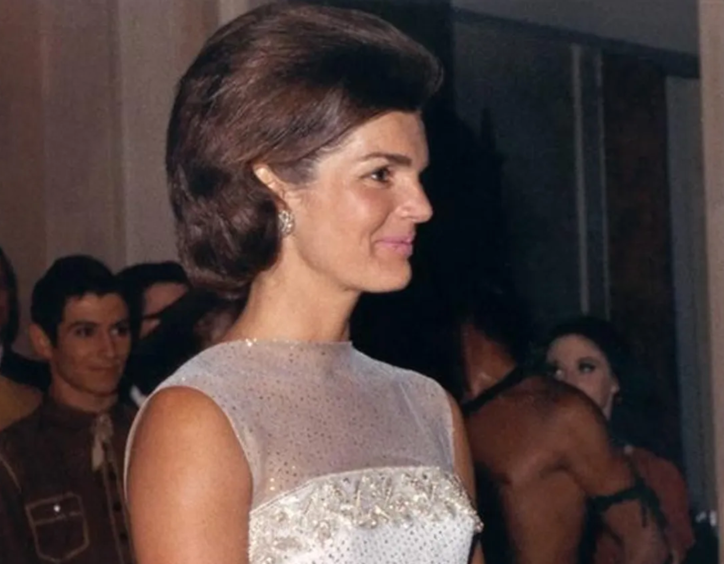 Jacqueline Kennedy stands at a 1962 State Dinner at the White House