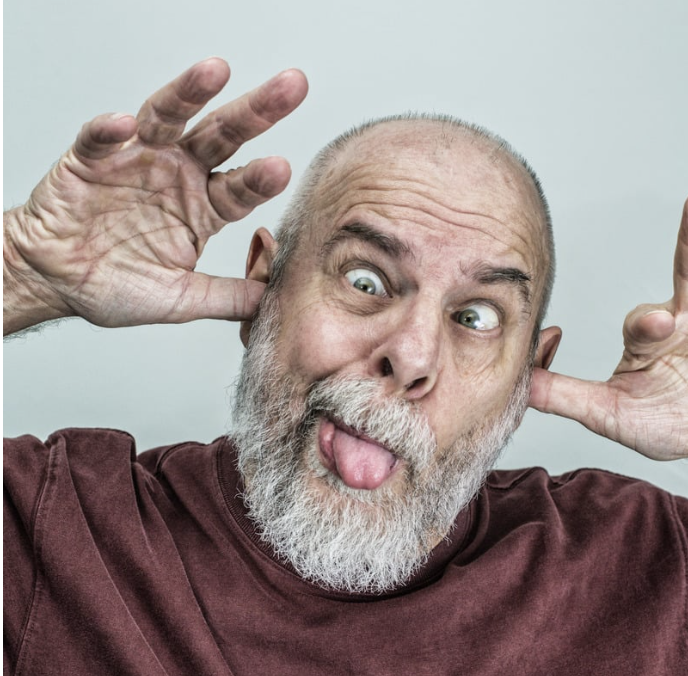 Old man sticking tongue, making goofy face
