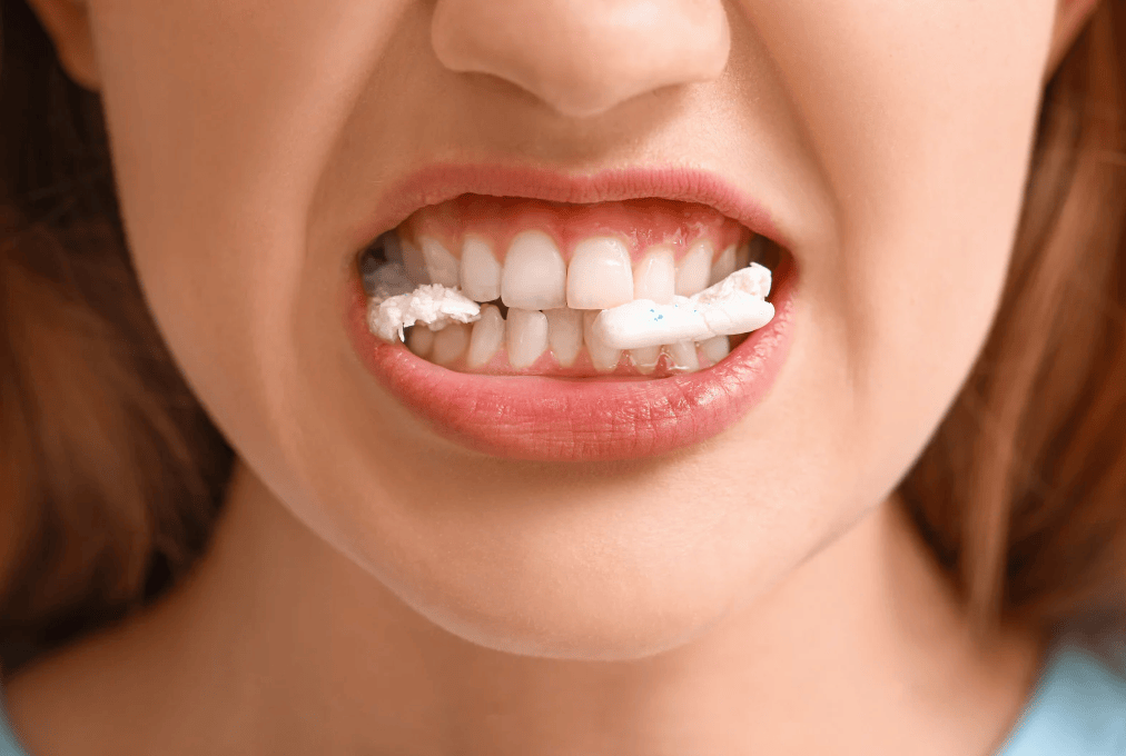 close up of a mouth chewing gum