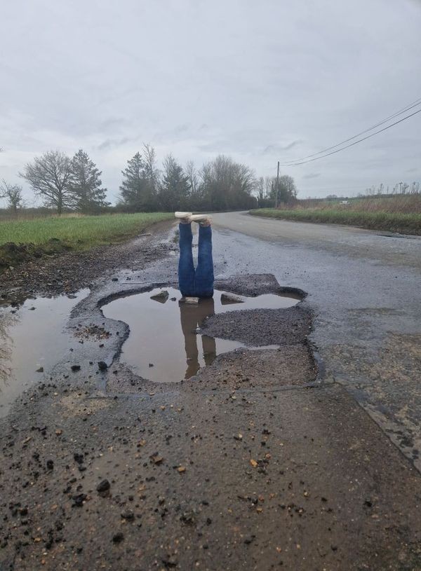 Feet sticking out of a pothole