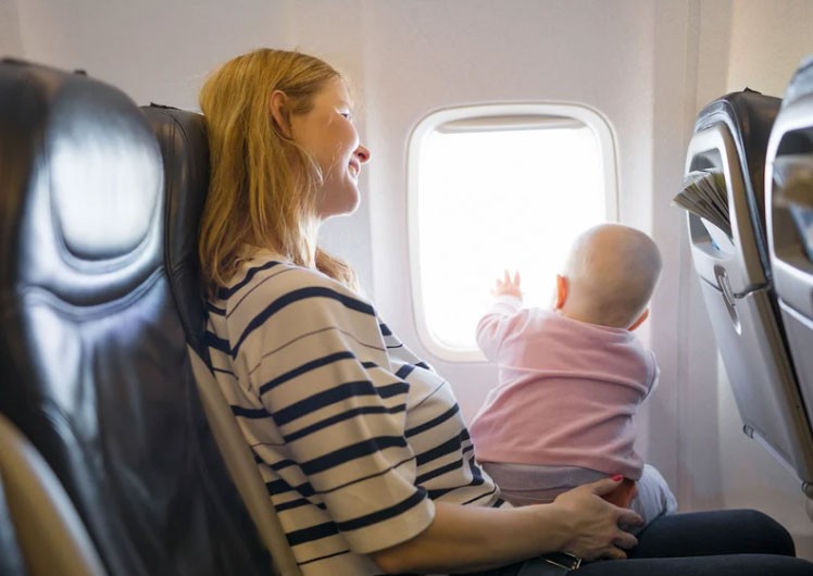 travel with toddlers, parenting forums, flying while pregnant, child seat swap, flight seat issues, mom opinions online