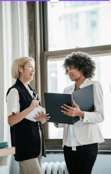 Two women talk in the office