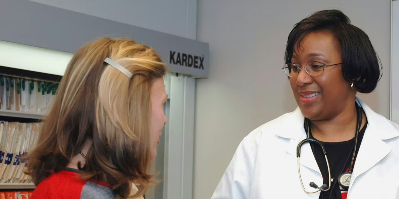 A doctor at the National Cancer Institute talks with a patient.