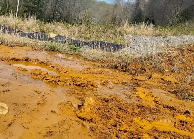 Metals flowing from acid mine waste make a creek look orange.