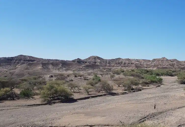 A dry valley landscape with layers in the rock.