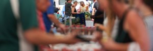 Customers browse the fresh produce at a Wilkes-Barre, Pa., farmers market in June 2025.