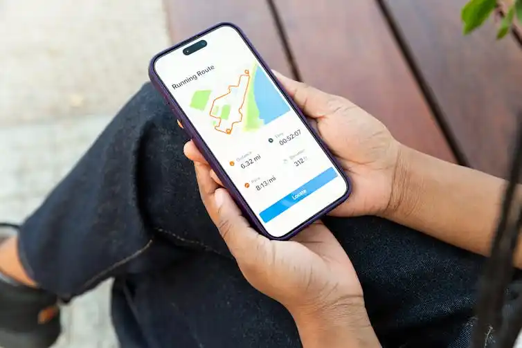 Hands holding a smartphone going a completed running route